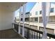 Exterior balcony view showcasing white drapes and neighborhood townhome architecture at 6569 Beacon Dr, Sandy Springs, GA 30328
