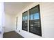 Exterior balcony with white horizontal siding, black framed windows, and curtains at 6569 Beacon Dr, Sandy Springs, GA 30328