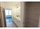 Well-lit bathroom boasts a double sink vanity and a wire rack shelving unit in the background at 6569 Beacon Dr, Sandy Springs, GA 30328