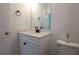 Bright powder room featuring a modern single sink vanity with quartz countertops and matte black fixtures at 6569 Beacon Dr, Sandy Springs, GA 30328