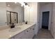 Bright bathroom featuring a double sink vanity with quartz countertops and sleek, matte black fixtures at 6569 Beacon Dr, Sandy Springs, GA 30328