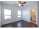 Bright bedroom featuring hardwood floors, a ceiling fan, and an ensuite bathroom at 6569 Beacon Dr, Sandy Springs, GA 30328