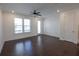 Well-lit bedroom with ceiling fan, windows, and a door leading to the outside at 6569 Beacon Dr, Sandy Springs, GA 30328