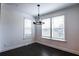 Bright dining area with modern chandelier, hardwood flooring, and white trim at 6569 Beacon Dr, Sandy Springs, GA 30328