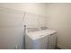 Laundry room featuring modern, white, front loading, washing machine and dryer at 6569 Beacon Dr, Sandy Springs, GA 30328
