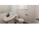 Modern powder room with stylish fixtures, paint, flooring, and lighting at 6569 Beacon Dr, Sandy Springs, GA 30328