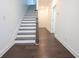 Hallway featuring a staircase with dark wood flooring, white trim, and natural lighting at 6569 Beacon Dr, Sandy Springs, GA 30328