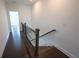 An indoor staircase with wood handrail and hardwood flooring at 6569 Beacon Dr, Sandy Springs, GA 30328