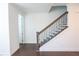 Stylish staircase with wood treads, iron spindles, and view of an open doorway at 6569 Beacon Dr, Sandy Springs, GA 30328