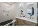 Bright bathroom featuring dual vanity sinks, walk-in shower, black hexagon tile, and modern fixtures at 1792 Charles Nw Pl, Atlanta, GA 30318