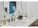 Close-up on bright double vanity sink in a modern bathroom with gold fixtures and upscale decor at 1792 Charles Nw Pl, Atlanta, GA 30318