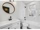 Stylish bathroom featuring marble-look tile, a white vanity, and modern fixtures at 1792 Charles Nw Pl, Atlanta, GA 30318