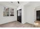 Bedroom features hardwood floors, a window, and a closet with black, double doors at 1792 Charles Nw Pl, Atlanta, GA 30318
