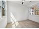 Bright bedroom featuring hardwood floors, two large windows, and a modern ceiling fan at 1792 Charles Nw Pl, Atlanta, GA 30318