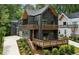 Modern home featuring a sleek, dark exterior with wooden accents and spacious balconies at 1792 Charles Nw Pl, Atlanta, GA 30318