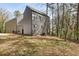 Modern home with gray siding and large windows nestled in a wooded landscape at 1792 Charles Nw Pl, Atlanta, GA 30318