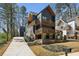 Contemporary two-story home showcasing a modern design with a dark exterior and wooden balconies and trim at 1792 Charles Nw Pl, Atlanta, GA 30318