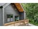 Exterior of house, showcasing balcony with wooden railing and wooded green views at 1792 Charles Nw Pl, Atlanta, GA 30318