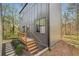 Modern home featuring wood stairs and gray siding with lush green surroundings at 1792 Charles Nw Pl, Atlanta, GA 30318