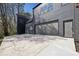 Modern two-story home with a wide concrete driveway and gray siding, showcasing a two-car garage at 1792 Charles Nw Pl, Atlanta, GA 30318