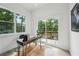 Bright home office featuring a modern desk with hairpin legs and a sliding door to a private balcony overlooking greenery at 1792 Charles Nw Pl, Atlanta, GA 30318