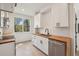 Well-lit kitchen featuring white cabinets, butcher block countertops, and stainless steel appliances at 1792 Charles Nw Pl, Atlanta, GA 30318