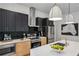 Modern kitchen featuring stainless steel appliances, two pendant lights, and black subway tile backsplash at 1792 Charles Nw Pl, Atlanta, GA 30318