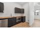 Modern kitchenette features dark cabinetry, stainless steel appliances, and butcher block countertops at 1792 Charles Nw Pl, Atlanta, GA 30318