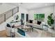 Cozy living room featuring modern furniture, a stylish staircase, and ample natural light at 1792 Charles Nw Pl, Atlanta, GA 30318