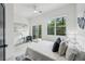 Serene main bedroom with a white textured headboard, a private balcony with green views and modern décor at 1792 Charles Nw Pl, Atlanta, GA 30318