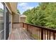 Private wooden deck with railing, providing a tranquil outdoor space adjacent to a lush wooded area at 223 Riverstone Commons Cir, Canton, GA 30114