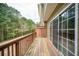 Wooden deck with railing offering a private outdoor space overlooking a lush green forest at 223 Riverstone Commons Cir, Canton, GA 30114