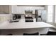 Bright kitchen with stainless steel appliances, white cabinets, and a spacious quartz countertop island at 223 Riverstone Commons Cir, Canton, GA 30114