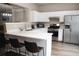 Bright kitchen with stainless steel appliances, white cabinets, and a spacious quartz countertop island at 223 Riverstone Commons Cir, Canton, GA 30114