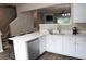 Open kitchen with white cabinetry, stainless appliances, quartz counters and eat-in counter with seating at 223 Riverstone Commons Cir, Canton, GA 30114