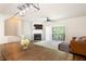 Open-concept space with a fireplace, ceiling fan, and sliding glass doors for natural light at 223 Riverstone Commons Cir, Canton, GA 30114