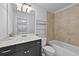 Bathroom featuring a black vanity, a bathtub, and a large mirror at 3022 Hartford Mill, Duluth, GA 30097