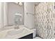 Bathroom featuring a white marble countertop, dark vanity and shower-tub combo at 3022 Hartford Mill, Duluth, GA 30097