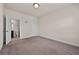 Bedroom with neutral colored walls, carpets, and a door to the en suite bathroom at 3022 Hartford Mill, Duluth, GA 30097