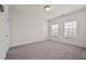This bedroom is bright and features neutral carpeting and two windows at 3022 Hartford Mill, Duluth, GA 30097
