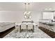 Modern dining area with stylish chairs, lighting, and seamless flow to the kitchen at 3022 Hartford Mill, Duluth, GA 30097