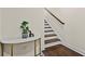 Entryway featuring a marble console table, hardwood floors and carpeted stairs at 3022 Hartford Mill, Duluth, GA 30097