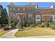 Charming brick townhome features a well-manicured lawn, inviting entrance, and classic architectural details at 3022 Hartford Mill, Duluth, GA 30097