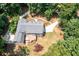 Aerial view of the gray house, surrounded by a beautiful green lawn and many tall trees at 4720 Timberland Sw Dr, Mableton, GA 30126