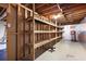 Unfinished basement with exposed wooden beams and built-in shelving, offering ample storage at 4720 Timberland Sw Dr, Mableton, GA 30126