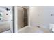 Bathroom with a glass shower door, tile floors, and access to an additional space at 4720 Timberland Sw Dr, Mableton, GA 30126