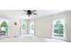 Bright bedroom with large windows offering backyard views, ceiling fan, and carpet floors at 4720 Timberland Sw Dr, Mableton, GA 30126