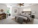 Comfortable bedroom with ample natural light, a decorative headboard, and a seating bench at 4720 Timberland Sw Dr, Mableton, GA 30126