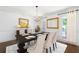 Formal dining room featuring modern decor, a chandelier, and a bright window, perfect for Gathering meals at 4720 Timberland Sw Dr, Mableton, GA 30126