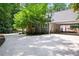 View of the house from the driveway that includes a covered carport, a concrete driveway, and some trees at 4720 Timberland Sw Dr, Mableton, GA 30126